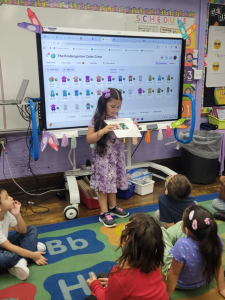 girl holding a sheet of paper